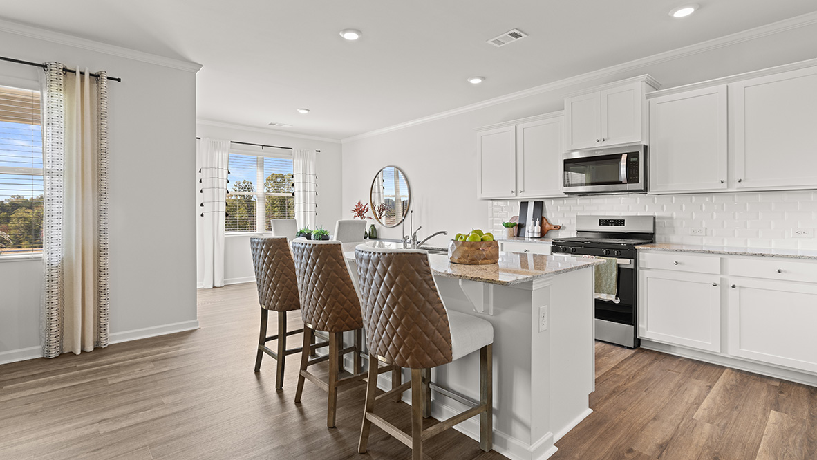 Interior kitchen with center island and white cabinets