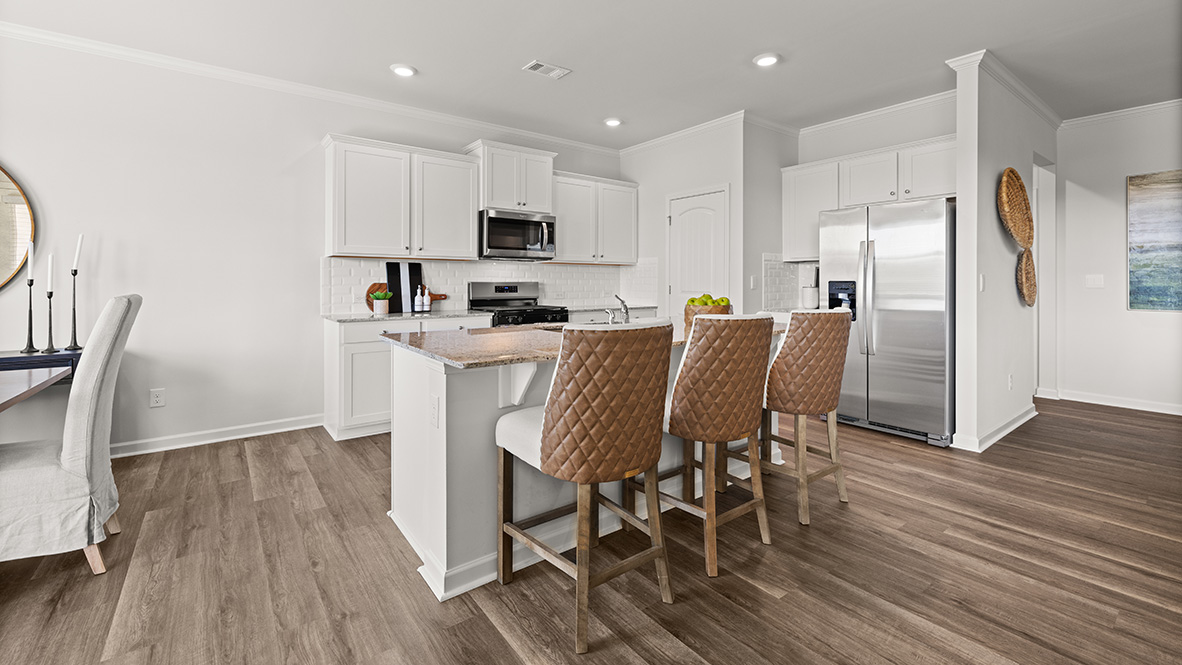 Interior kitchen with center island and white cabinets