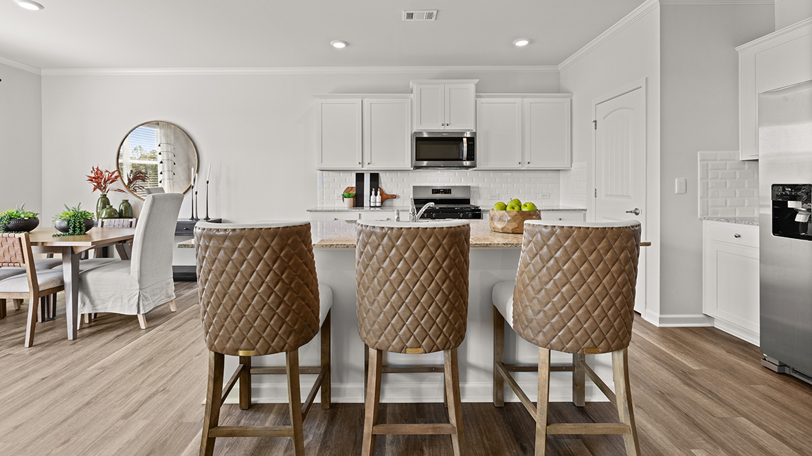Interior kitchen with center island and white cabinets