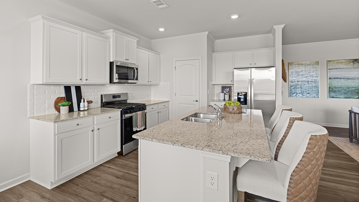 Interior kitchen with center island and white cabinets