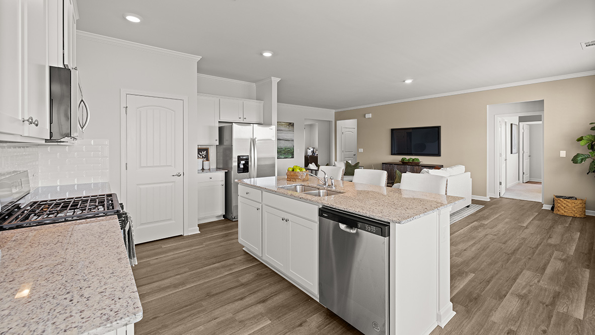 Interior kitchen with center island and white cabinets