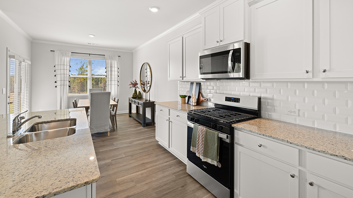 Interior kitchen with center island and white cabinets