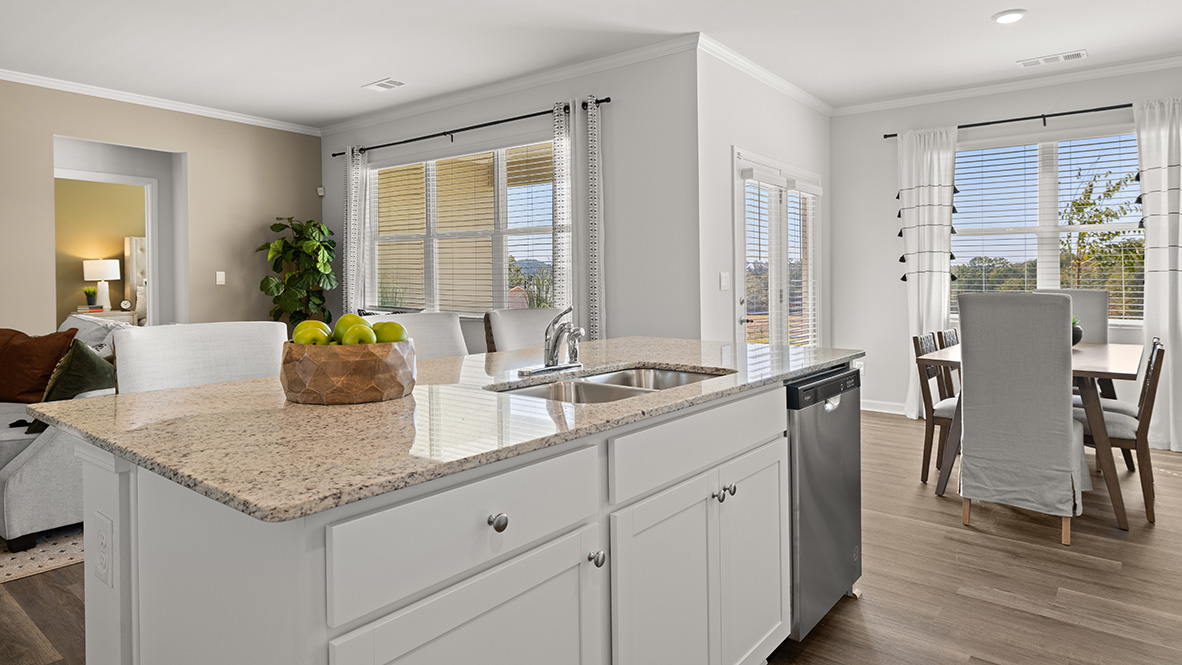 Interior kitchen with center island and white cabinets