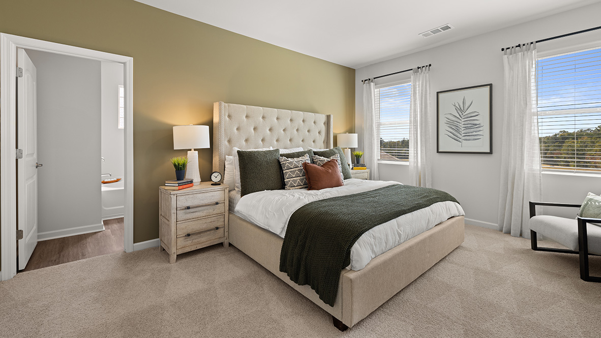 Interior primary bedroom with large windows