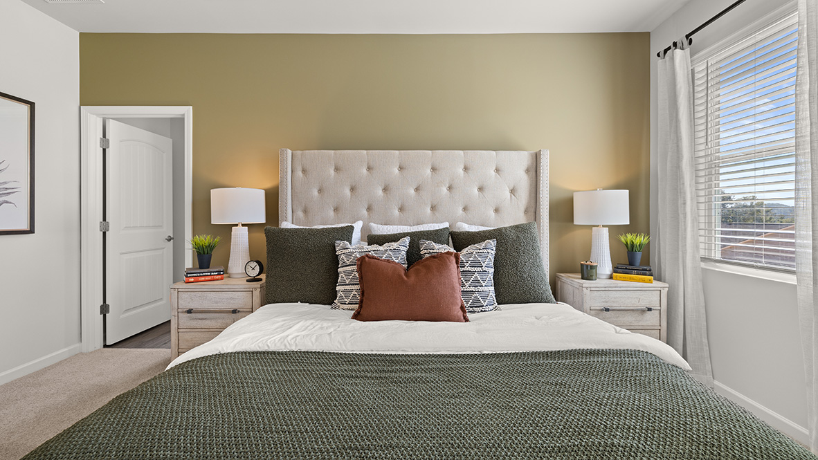 Interior primary bedroom with large windows