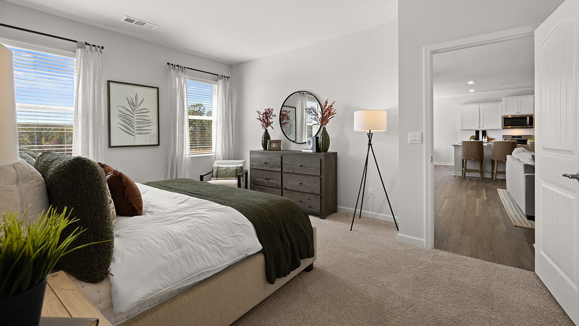 Interior primary bedroom with large windows