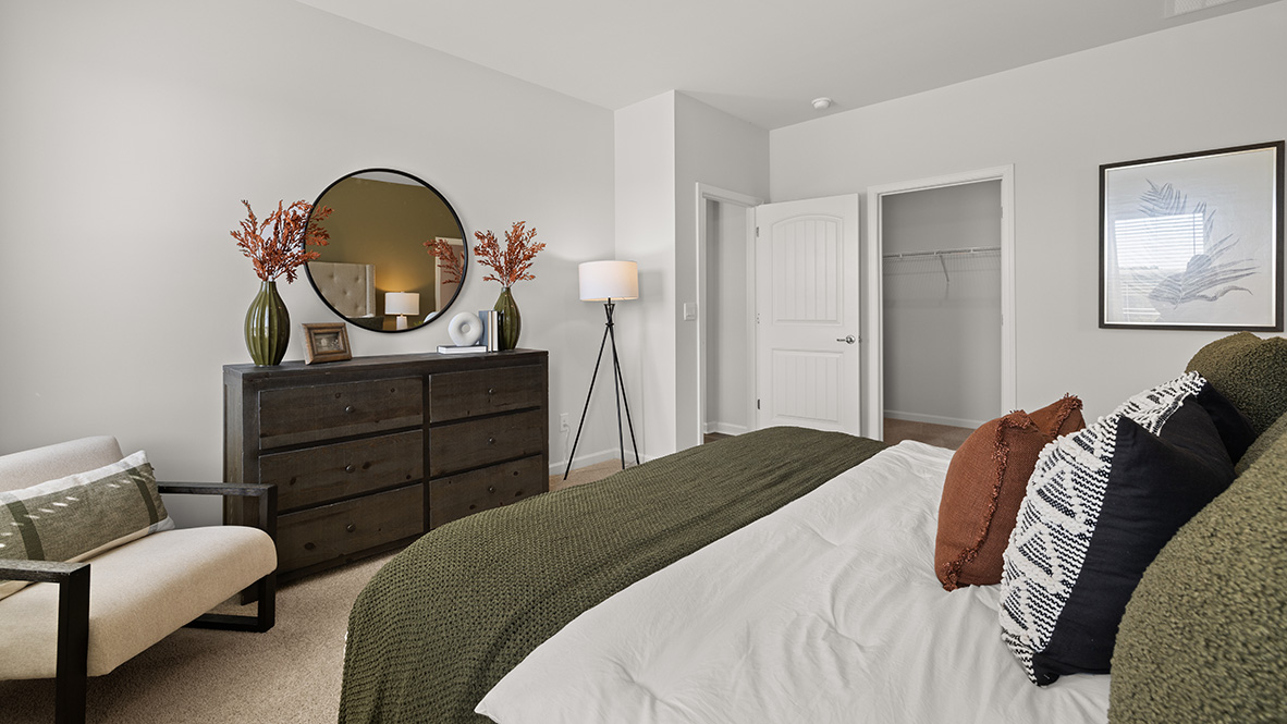 Interior primary bedroom with large windows