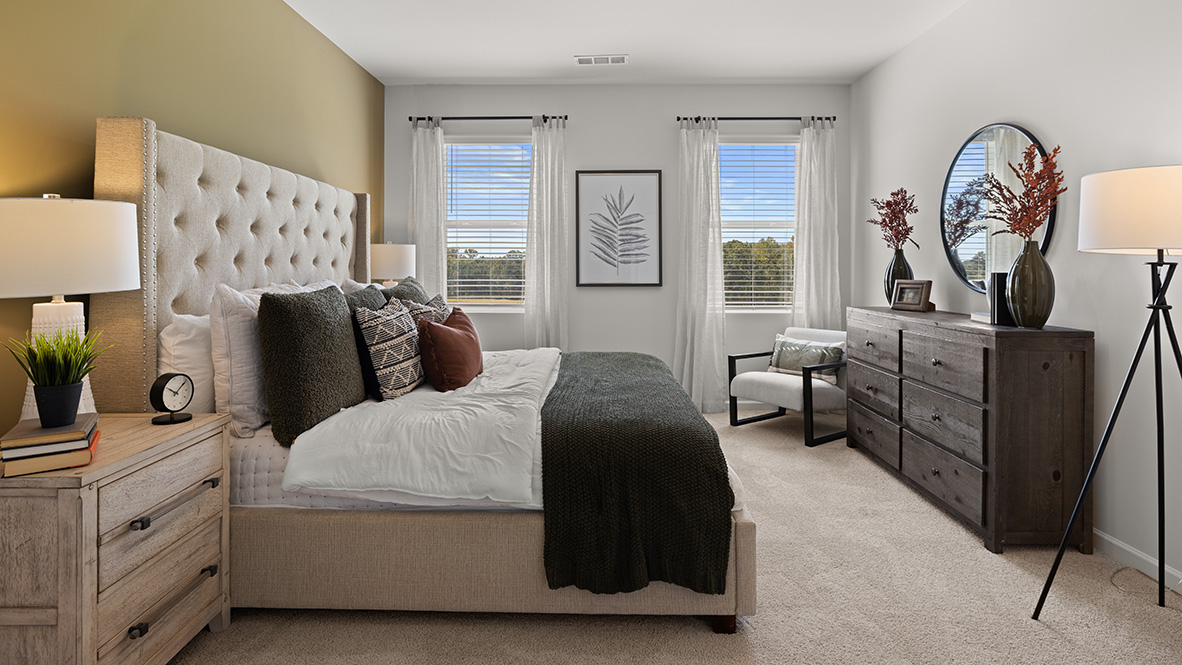 Interior primary bedroom with large windows