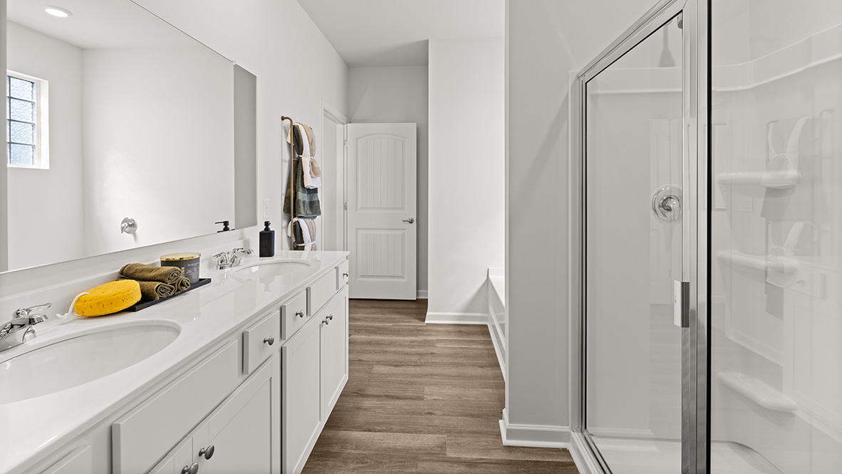 Interior primary bathroom with shower and double sink