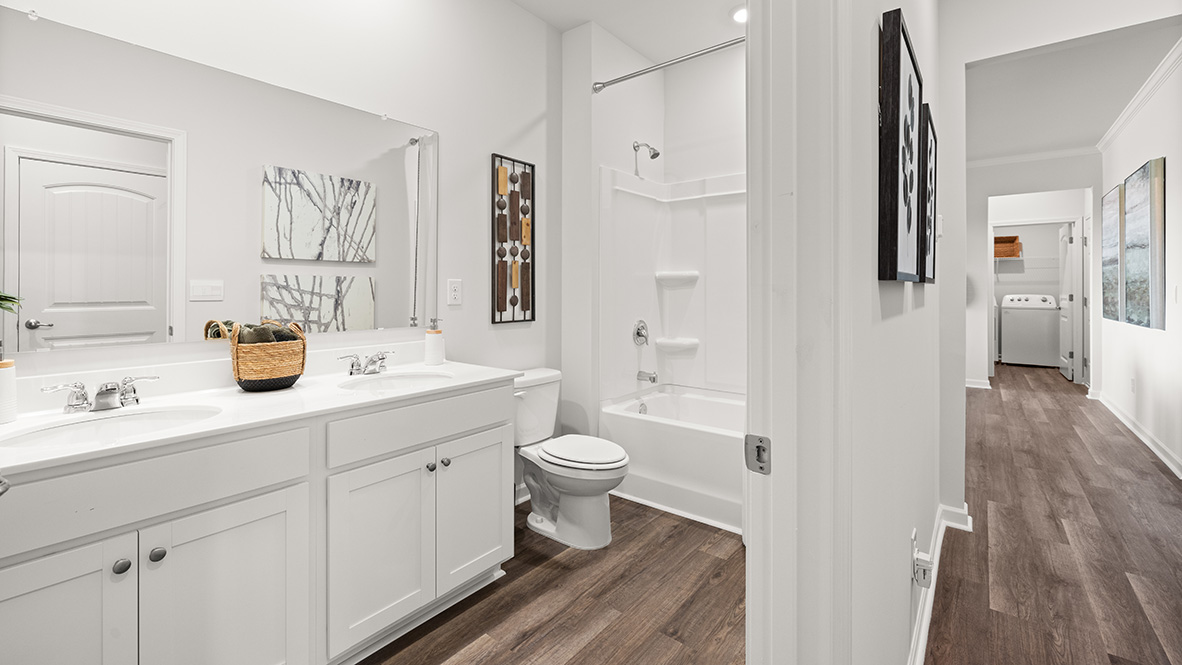 Interior bathroom with double sink and full-sized shower