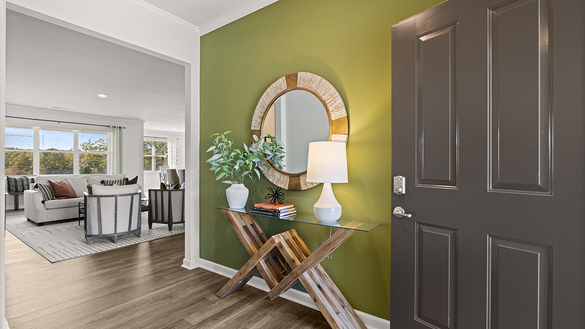 Interior entry-way with accent wall leading to living area