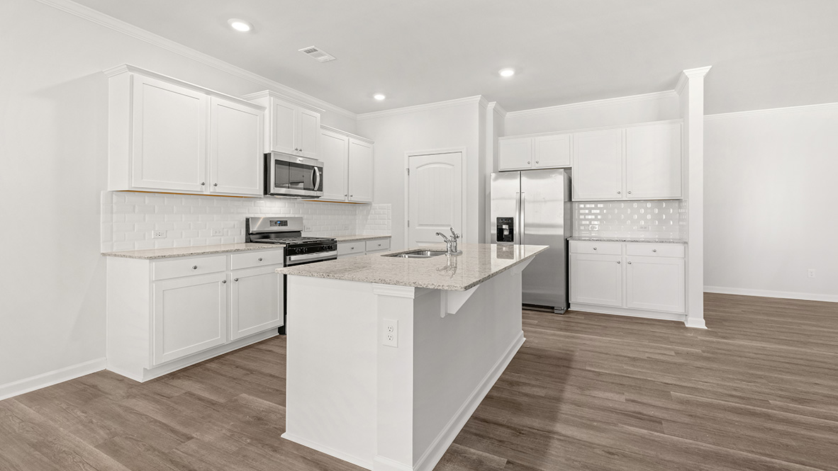 Interior kitchen with center island and white cabinets