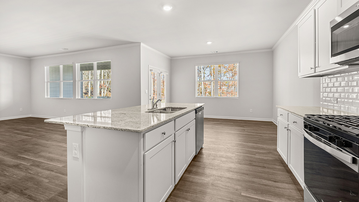 Interior kitchen with center island and white cabinets