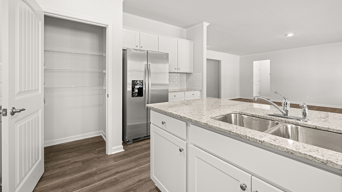Interior kitchen with center island and white cabinets