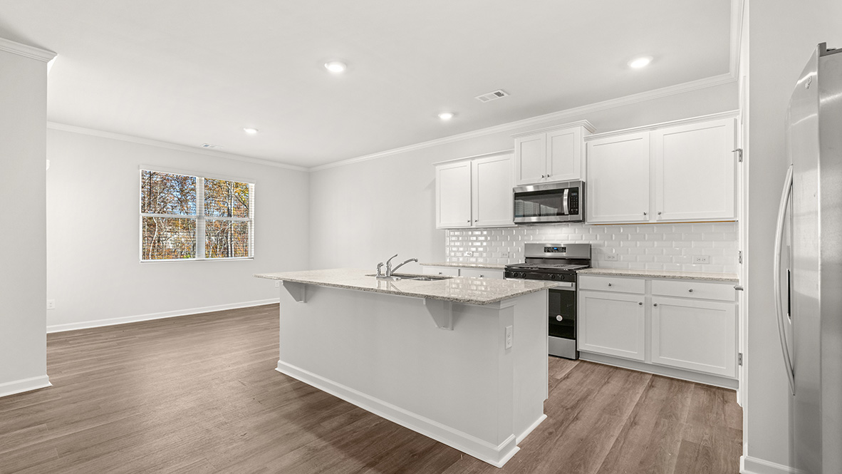 Interior kitchen with center island and white cabinets
