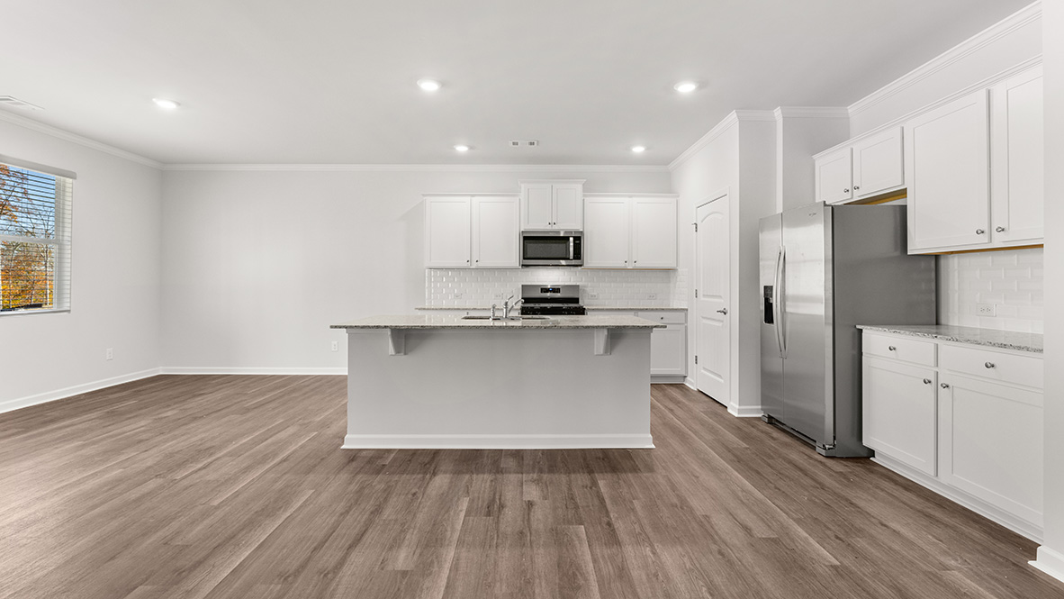 Interior kitchen with center island and white cabinets