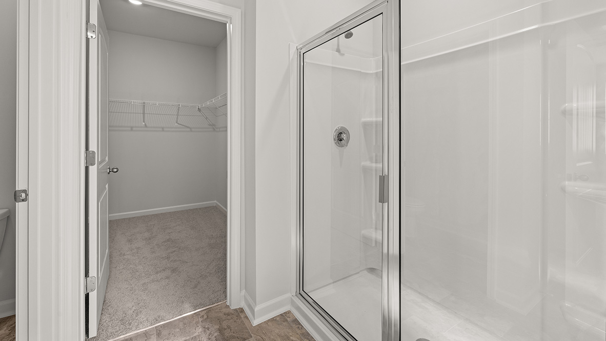 Interior primary bathroom with bath tub and sink next to window