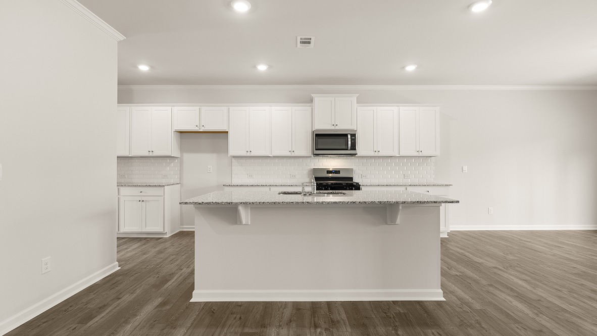 Interior kitchen with center island and white cabinets