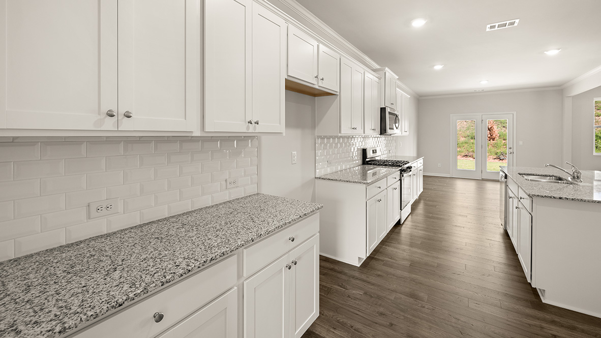 Interior kitchen with center island and white cabinets