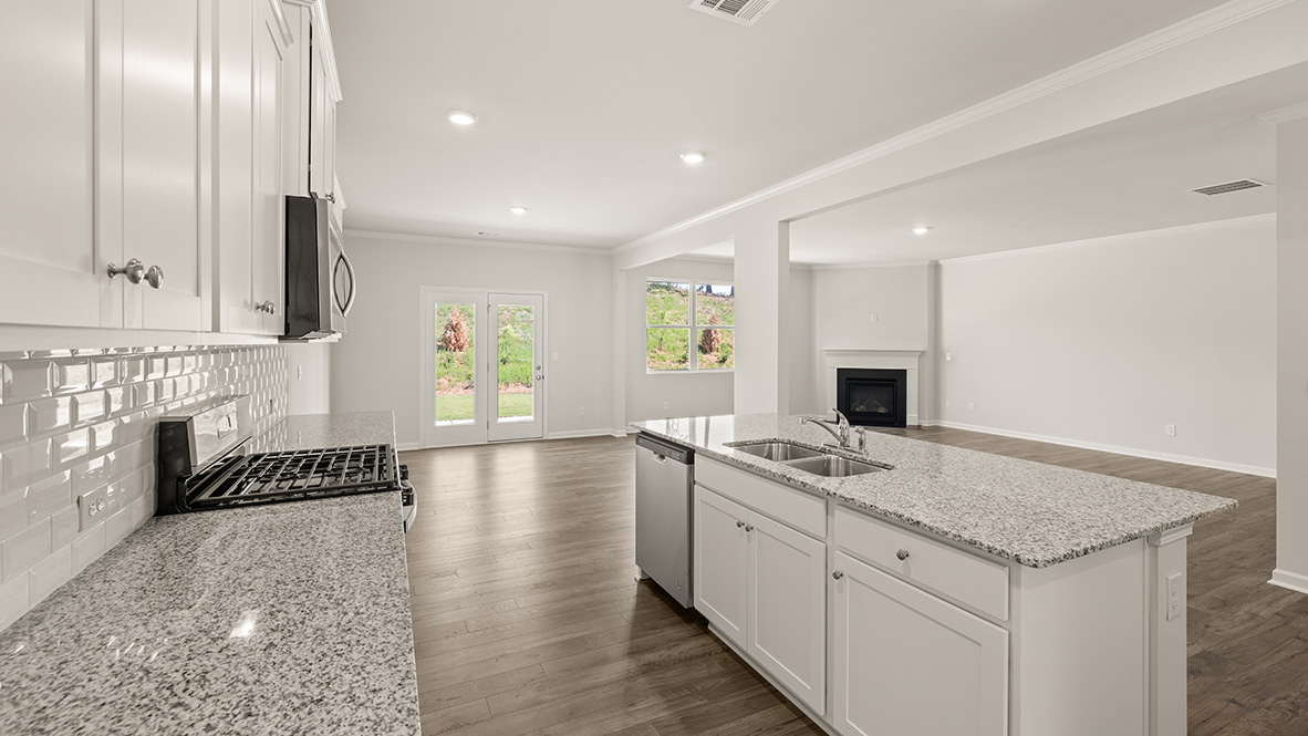 Interior kitchen with center island and white cabinets