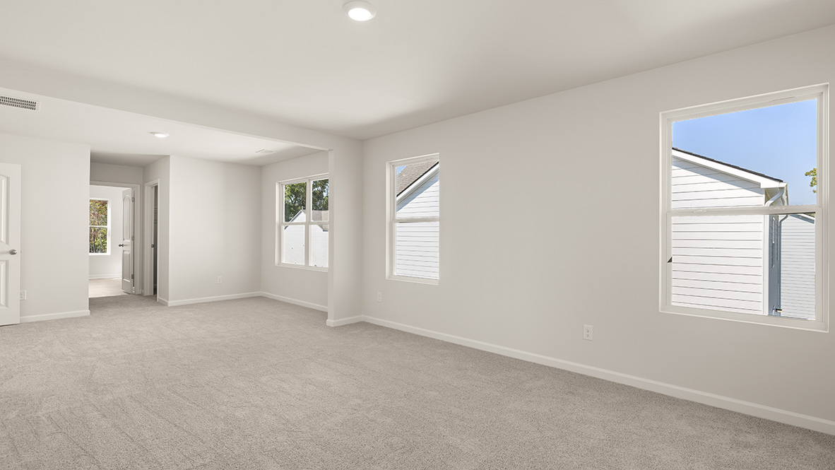 Interior primary bedroom with large windows