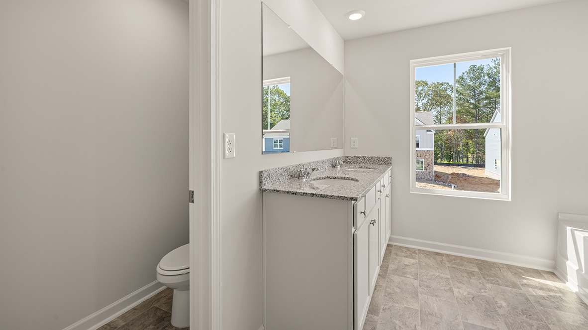 Interior primary bathroom with sink and bath tub