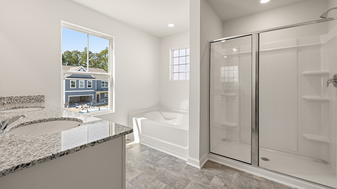 Interior primary bathroom with sink, bath tub and shower
