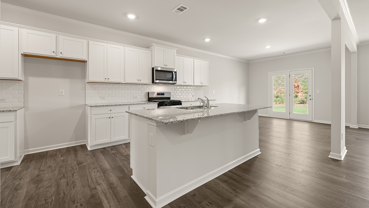 Interior kitchen with center island and white cabinets