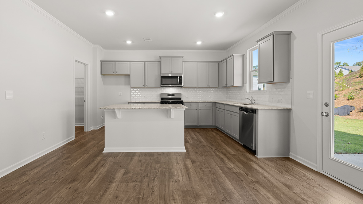 Interior kitchen with center island and light grey cabinets