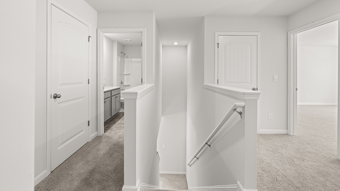 Interior upstairs loft area next to staircase and bedrooms