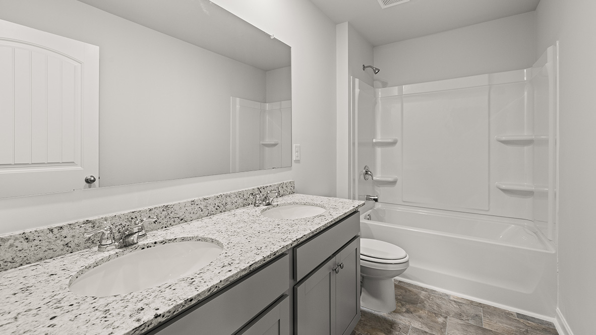 Interior bathroom with double sink and full-sized shower