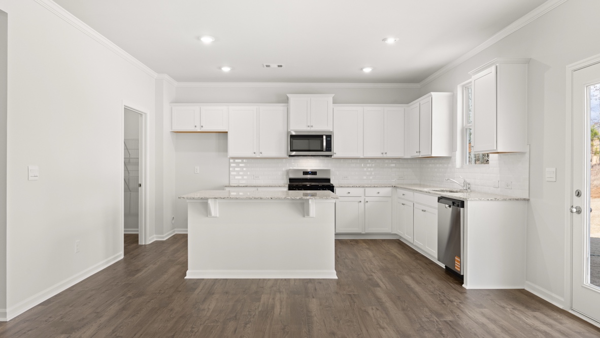 Interior kitchen with center island and white cabinets