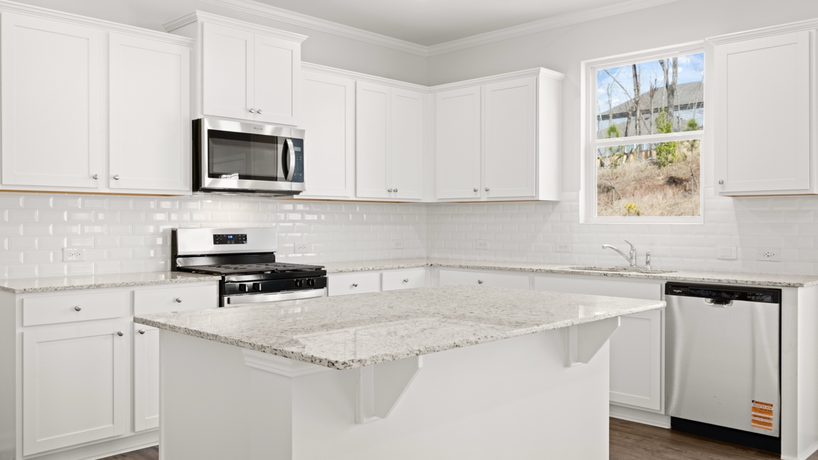 Interior kitchen with center island and white cabinets