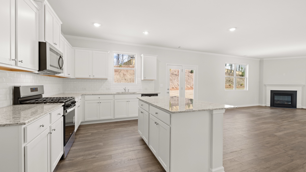 Interior kitchen with center island and white cabinets