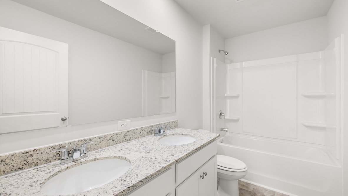 Interior bathroom with double sink and full-sized shower