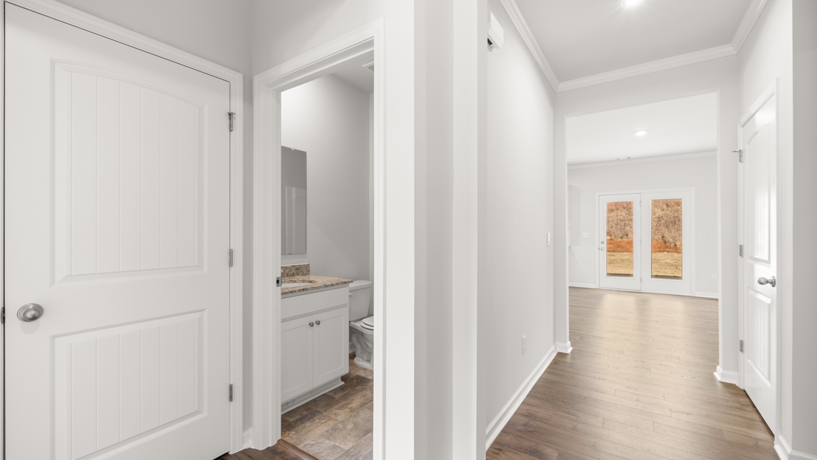 Interior bathroom with sink and full-sized shower looking down hallway