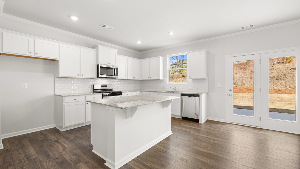 Interior kitchen with center island and white cabinets