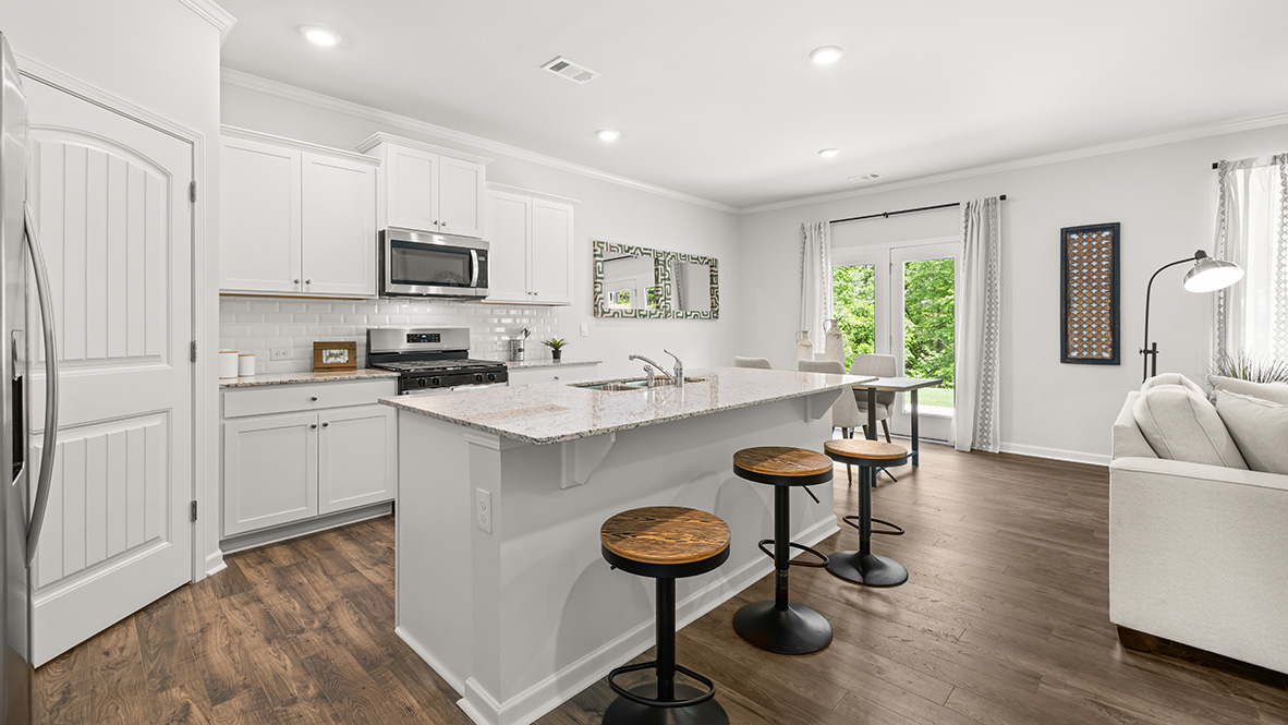 Interior kitchen with center island and white cabinets