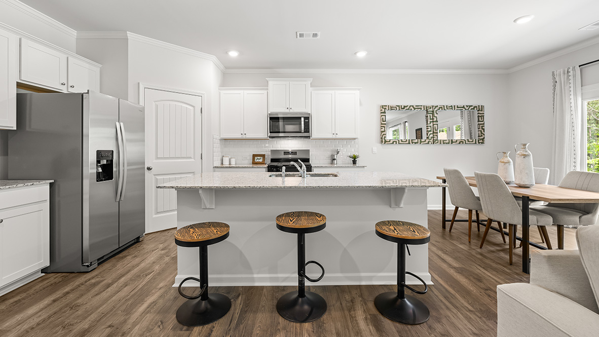Interior kitchen with center island and white cabinets