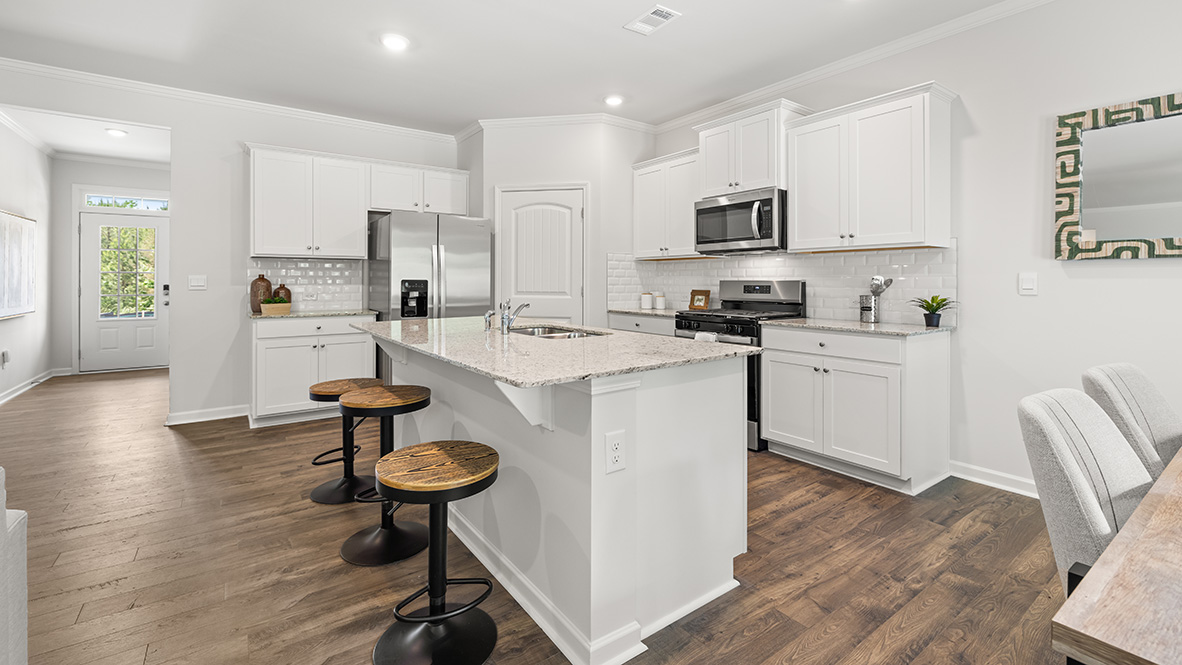 Interior kitchen with center island and white cabinets
