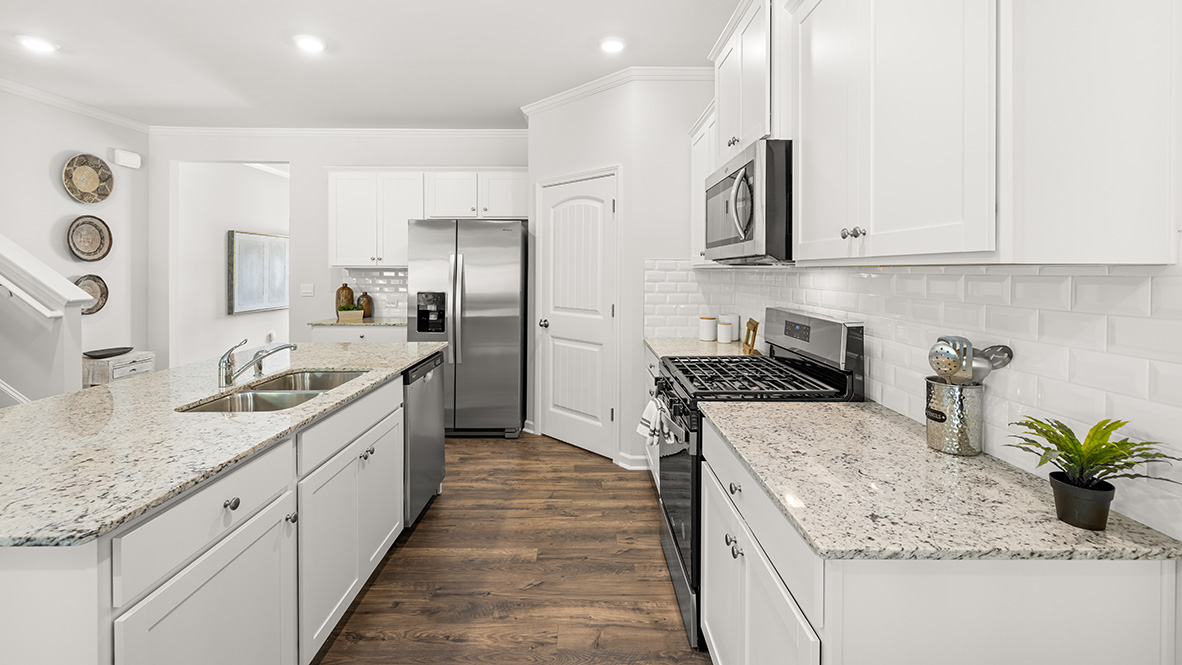 Interior kitchen with center island and white cabinets
