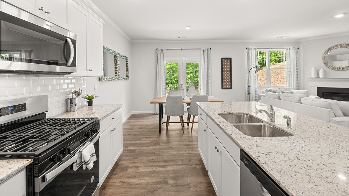 Interior kitchen with center island and white cabinets
