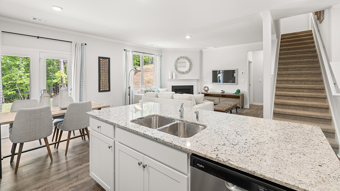 Interior kitchen with center island and white cabinets