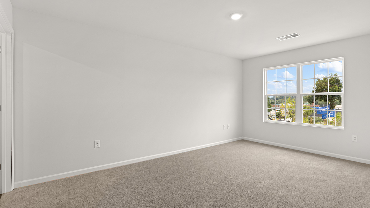 Interior primary bedroom with large window