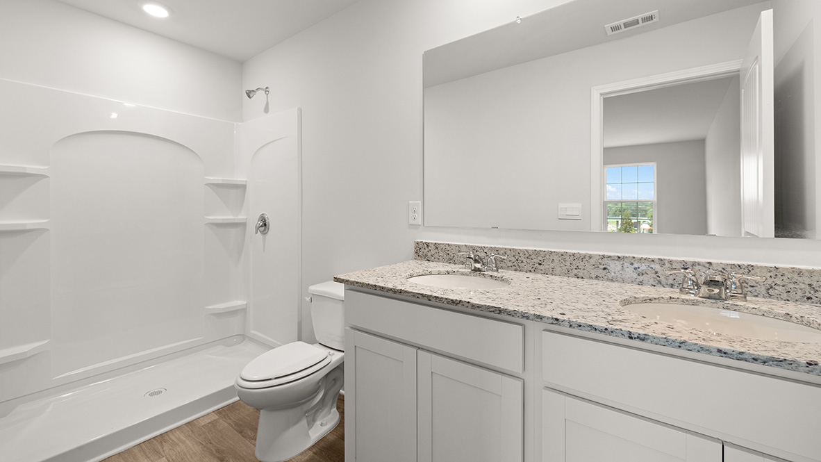Interior primary bathroom with double sink and shower