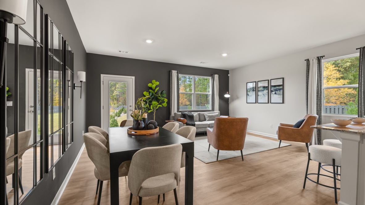 Interior dining area open to living area with large windows