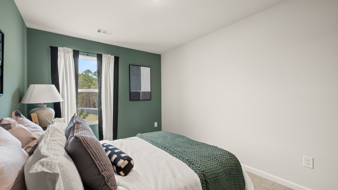 Interior bedroom with accent wall and window