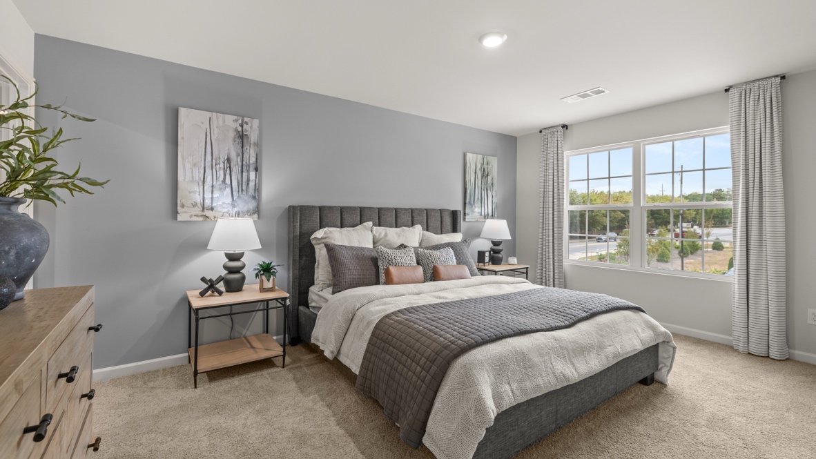 Interior primary bedroom with large window