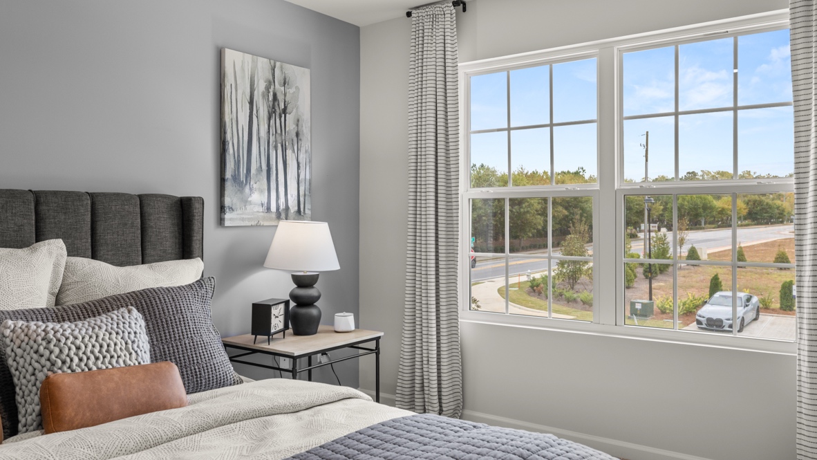 Interior primary bedroom with large window