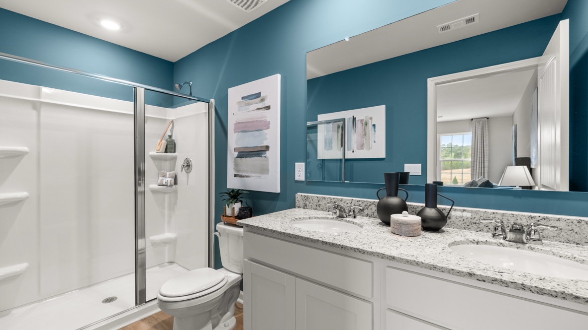 Interior primary bathroom with double sink and shower